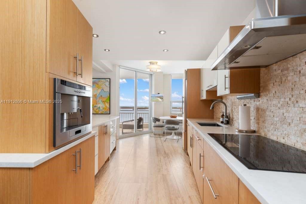 808 Brickell Key Drive, Unit 2504 Miami, FL 33131 - Photo 10 of 26 a large kitchen with stainless steel appliances a sink a counter top space a stove and a refrigerator