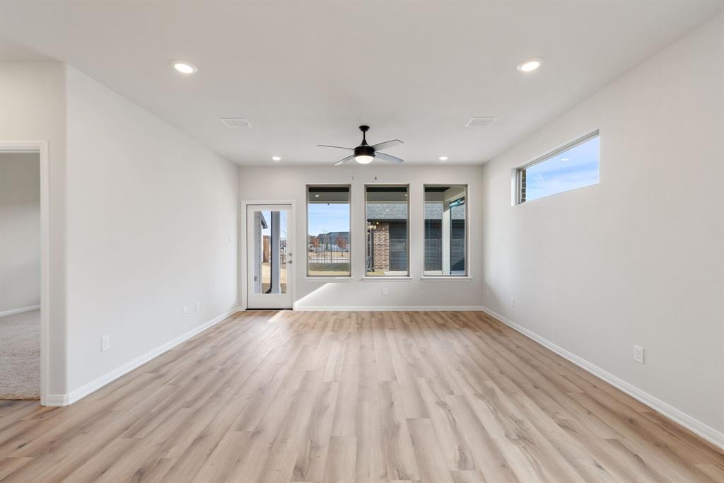 1847 Cole Road Van Alstyne, TX 75495 - Photo 8 of 26 Featuring a wall of windows overlooking the back and easy to maintain wood-look flooring, the entire family will love gathering in this great family room.