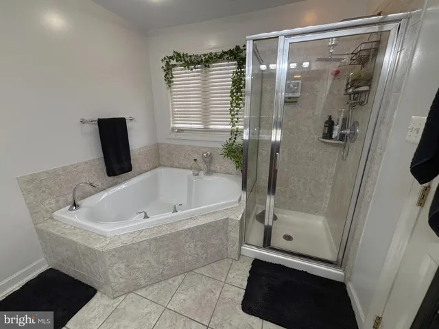 a bathroom with a bathtub a toilet and a shower