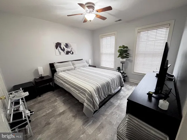 a bedroom with a bed gym equipment and a window