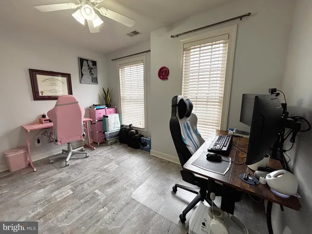 a view of a workspace with furniture and a window