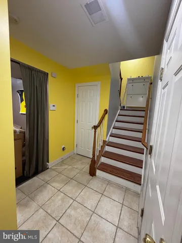 a view of entryway with wooden floor and stairs