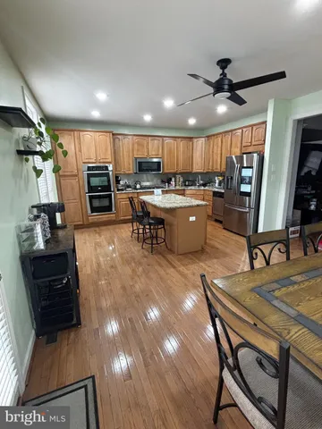 a large kitchen with a table and chairs