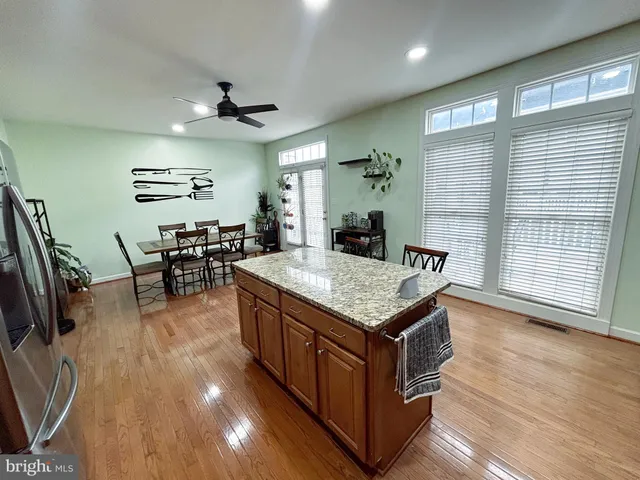 a kitchen with stainless steel appliances granite countertop a stove and a large window
