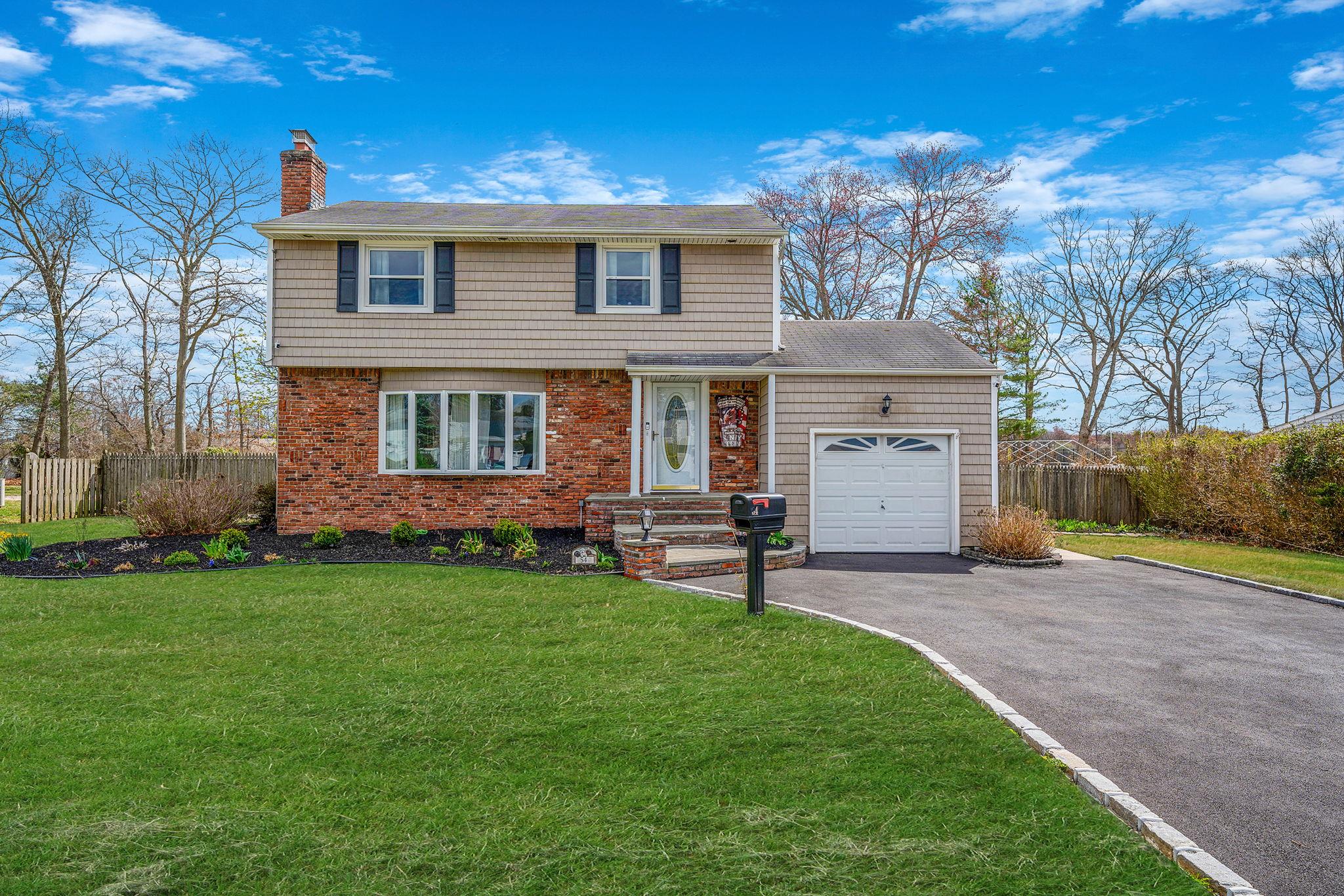 54 Higgins Street North Babylon, NY 11703 - Photo 1 of 1 a front view of a house with a garden