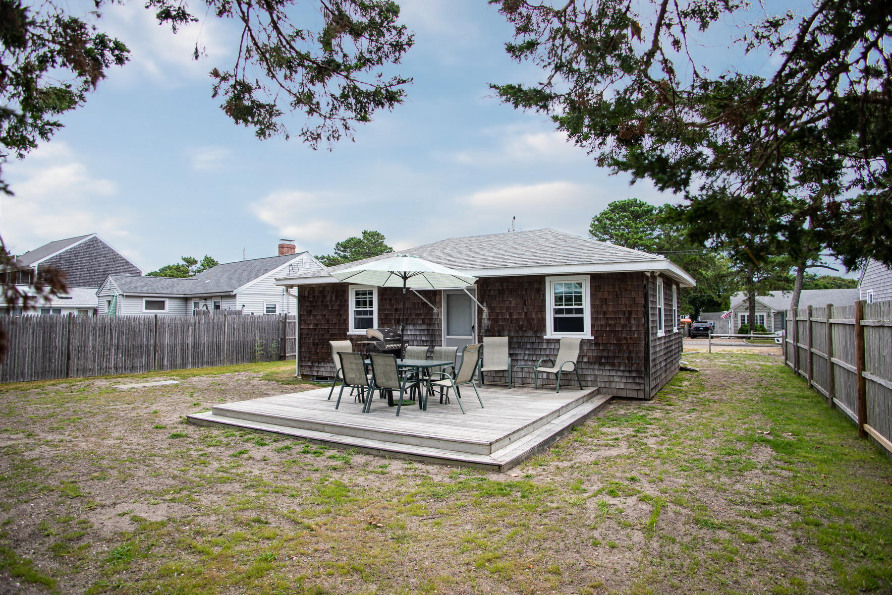 73 Uncle Rolf Road Dennis Port, MA 02639 - Photo 4 of 23 a view of house with backyard and outdoor seating