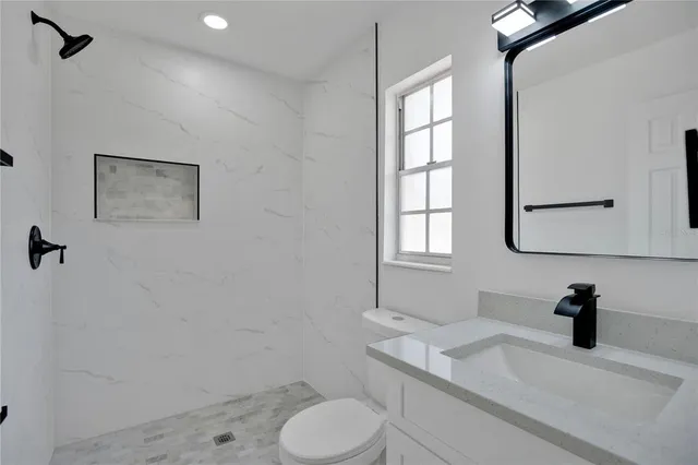 a view of room with a window and a ceiling fan