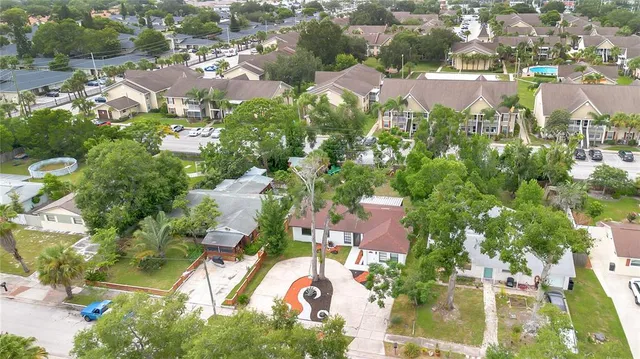 a yellow house with trees in front of it