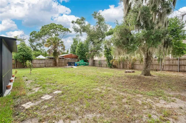 an aerial view of residential houses with outdoor space and river