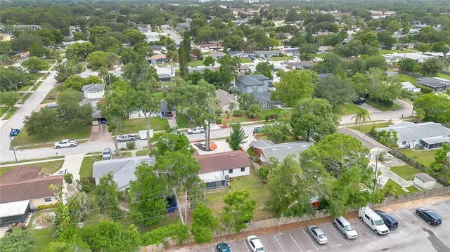 an aerial view of a residential houses with outdoor space and street view