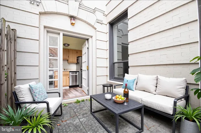 a outdoor living space with furniture and a potted plant