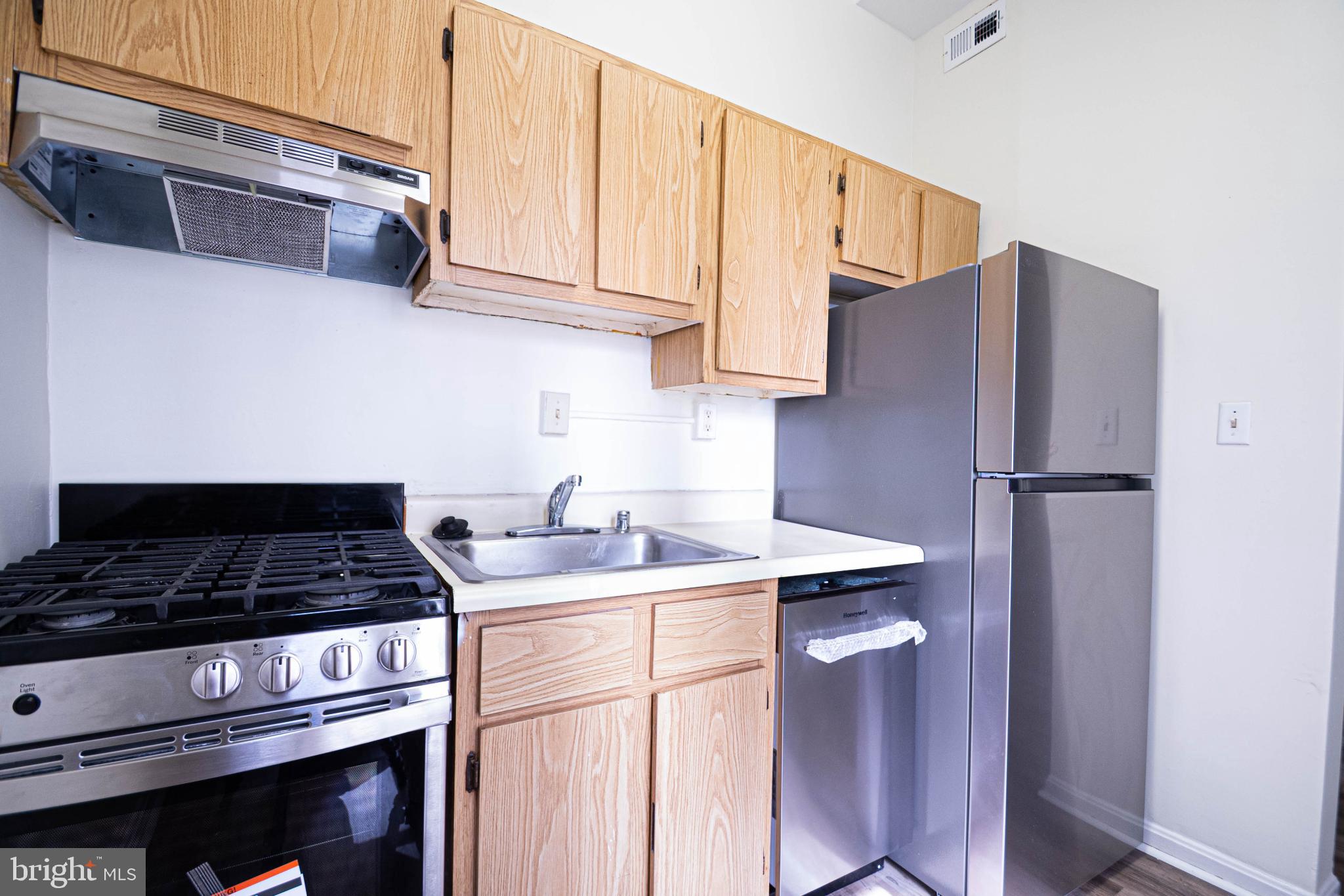 1669 Columbia Road Northwest, Unit 109 Washington, DC 20009 - Photo 17 of 35 a kitchen with stainless steel appliances granite countertop a sink stove and refrigerator
