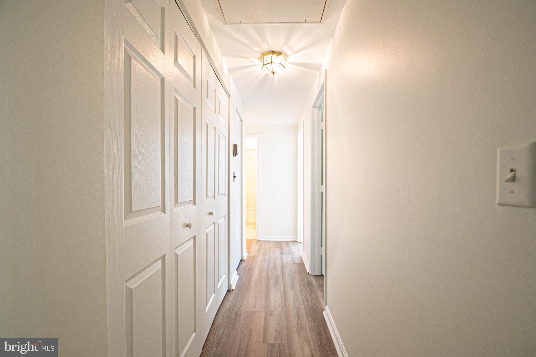 1669 Columbia Road Northwest, Unit 109 Washington, DC 20009 - Photo 19 of 35 a view of a hallway with wooden floor and staircase