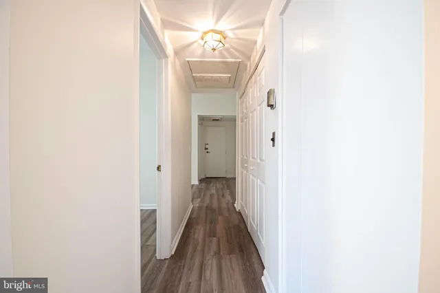 a view of a hallway with wooden floor
