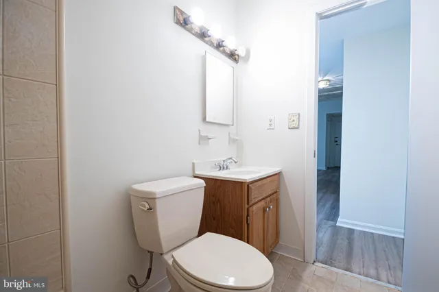 a white toilet sitting next to a bathroom sink