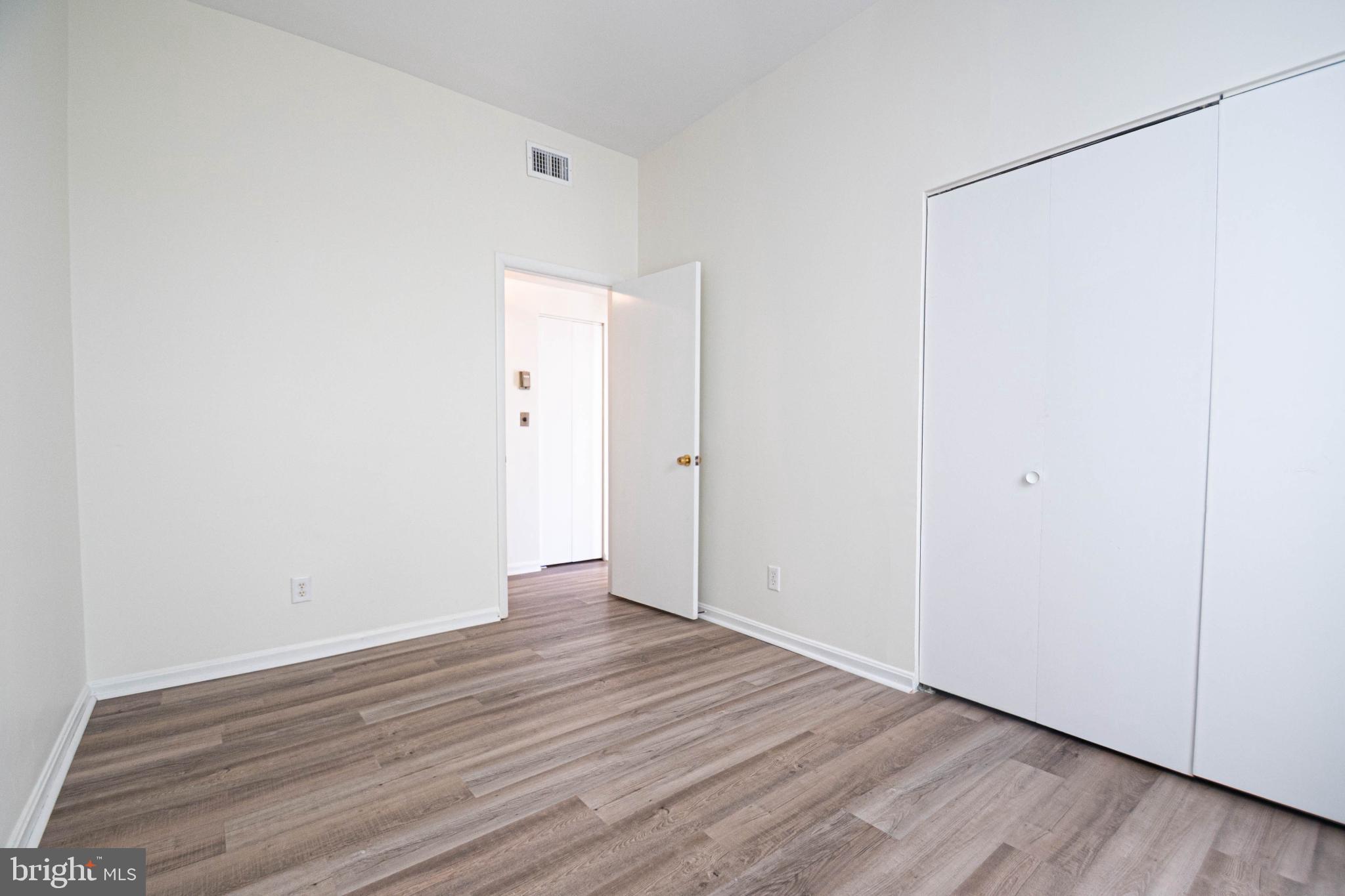 1669 Columbia Road Northwest, Unit 109 Washington, DC 20009 - Photo 29 of 35 a view of an empty room with wooden floor
