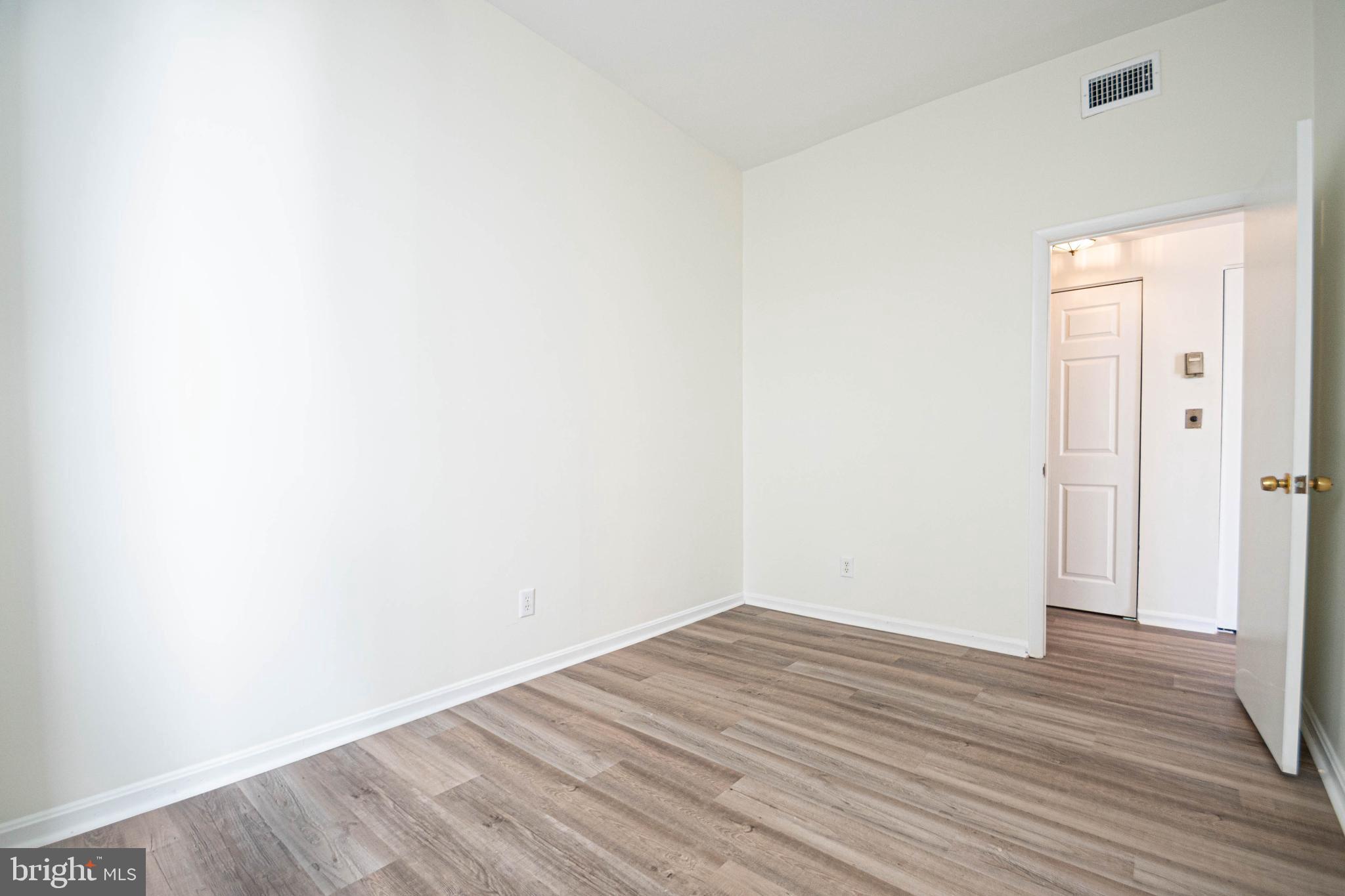 1669 Columbia Road Northwest, Unit 109 Washington, DC 20009 - Photo 30 of 35 a view of an empty room with wooden floor