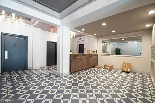 a kitchen with stainless steel appliances kitchen island granite countertop a refrigerator and a sink