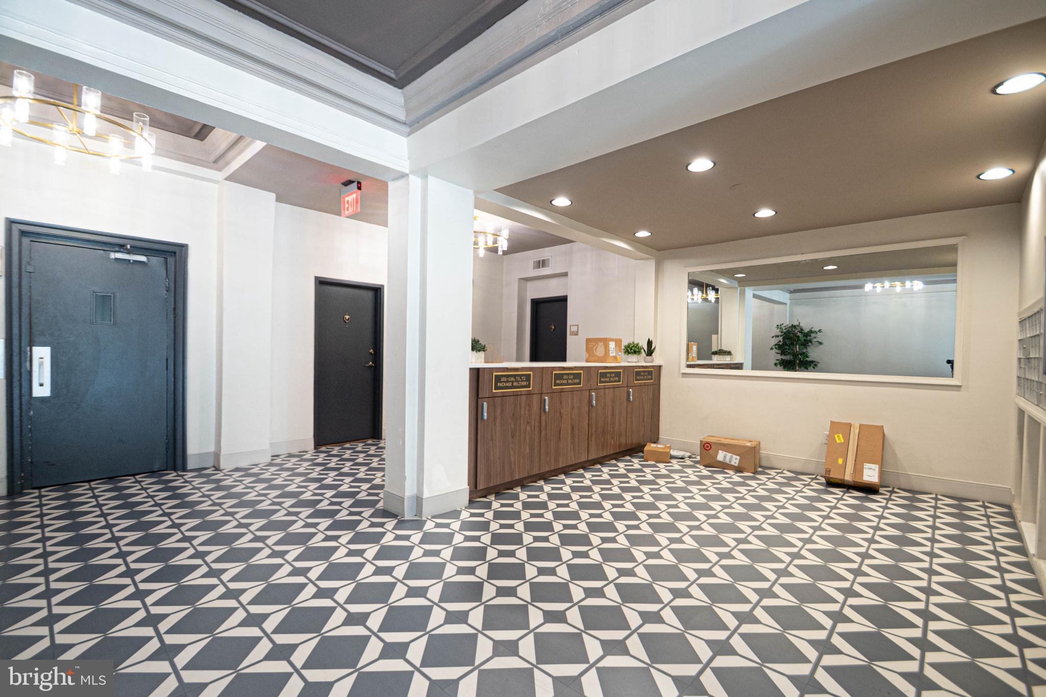1669 Columbia Road Northwest, Unit 109 Washington, DC 20009 - Photo 6 of 35 a kitchen with stainless steel appliances kitchen island granite countertop a refrigerator and a sink