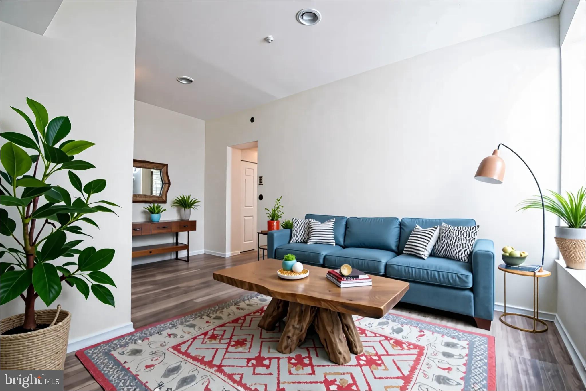 1669 Columbia Road Northwest, Unit 109 Washington, DC 20009 - Photo 8 of 35 a living room with furniture a potted plant and a wooden floor