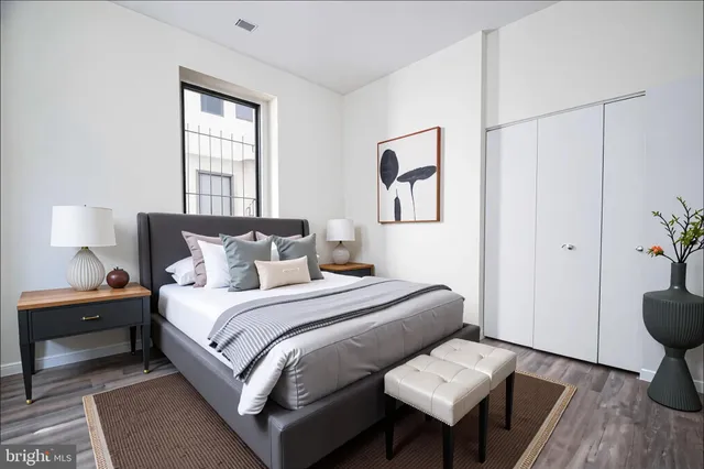 a bedroom with bed and a window