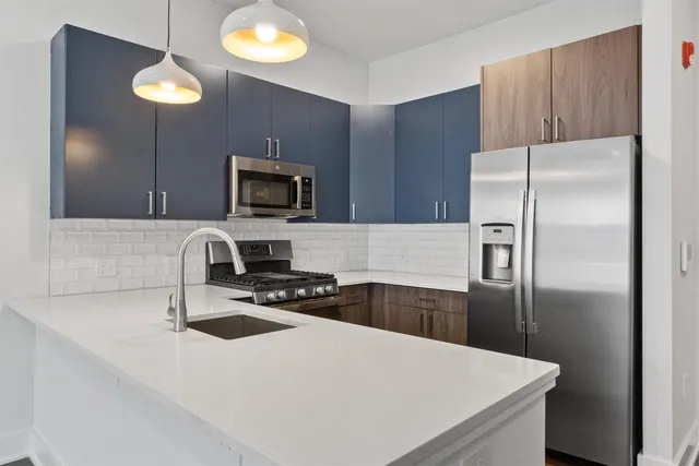 a kitchen with a refrigerator and a sink