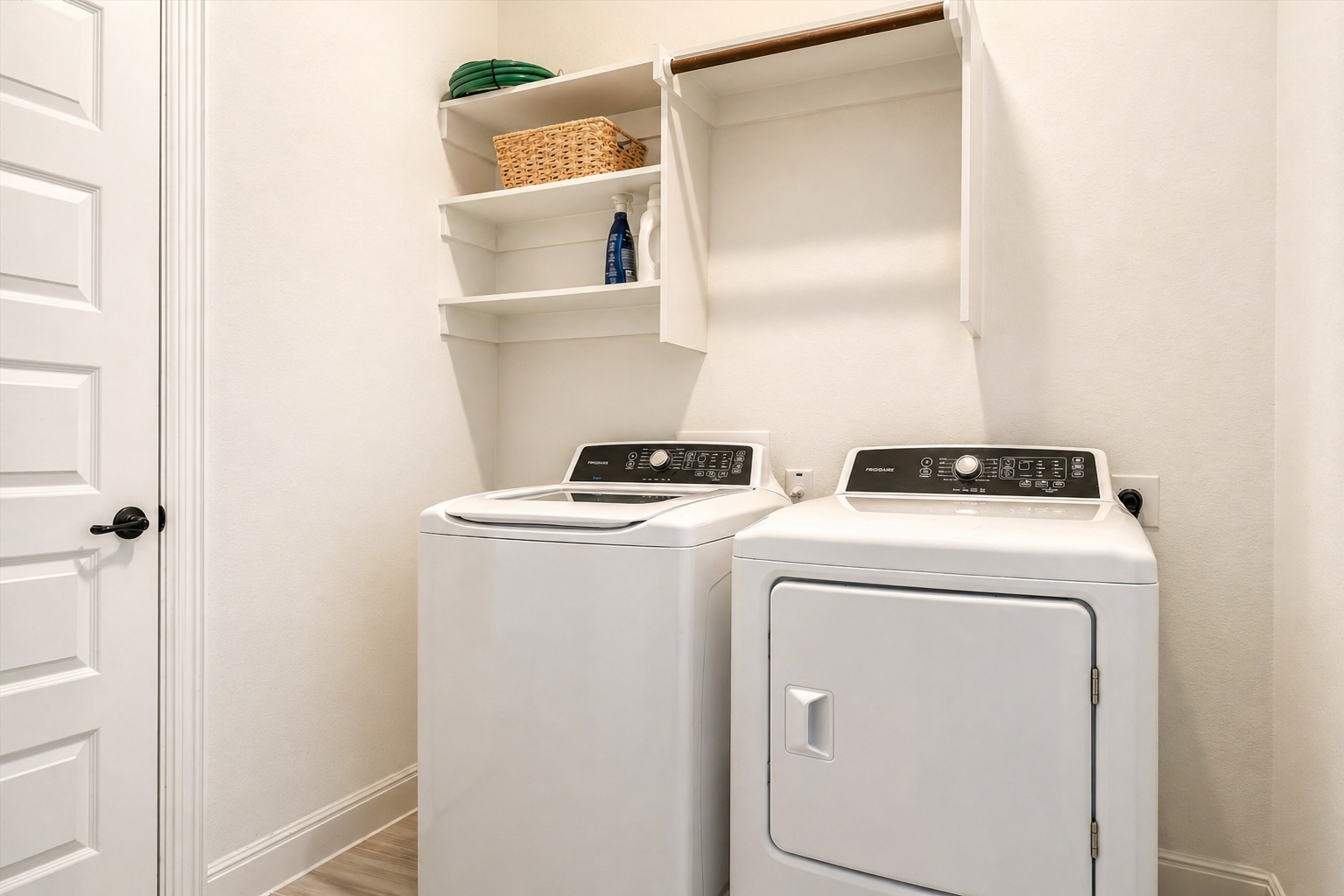 209 Rainier Drive Kyle, TX 78640 - Photo 19 of 24 Dedicated laundry area featuring built-in shelving, a clothes rod, and wood-finish flooring