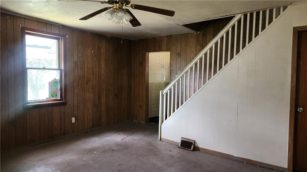 1116 Grant Street Vandergrift, PA 15690 - Photo 2 of 10 a view of a livingroom with a flesh screen tv and stairs