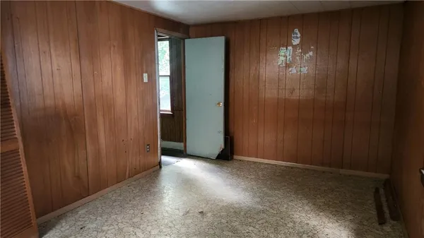 a view of an empty room with closet area
