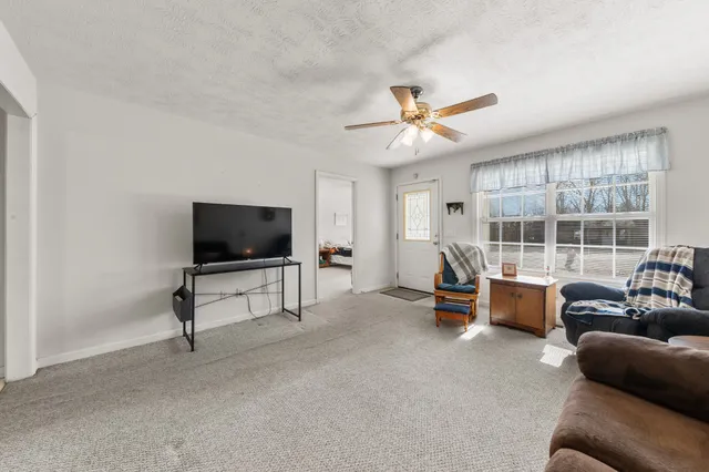 a large kitchen with stainless steel appliances kitchen island granite countertop a stove a sink a dining table and chairs