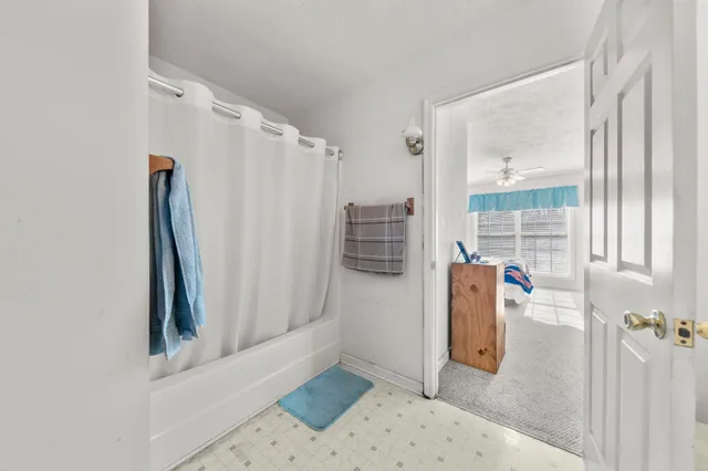 a bathroom with a toilet and a shower curtain