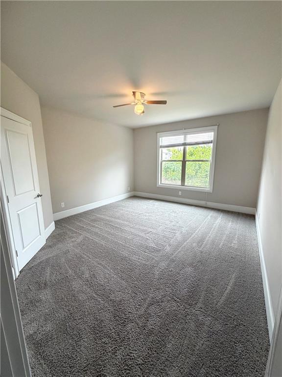 5296 Cheval Rue Court Suwanee, GA 30024 - Photo 17 of 51 an empty room with windows and fan