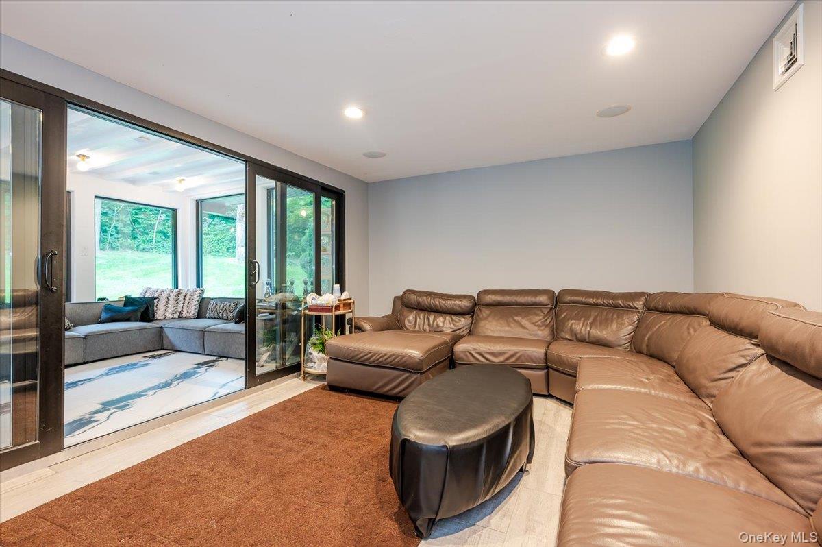 26 Redbrook Road Great Neck, NY 11024 - Photo 11 of 19 a living room with furniture and large windows