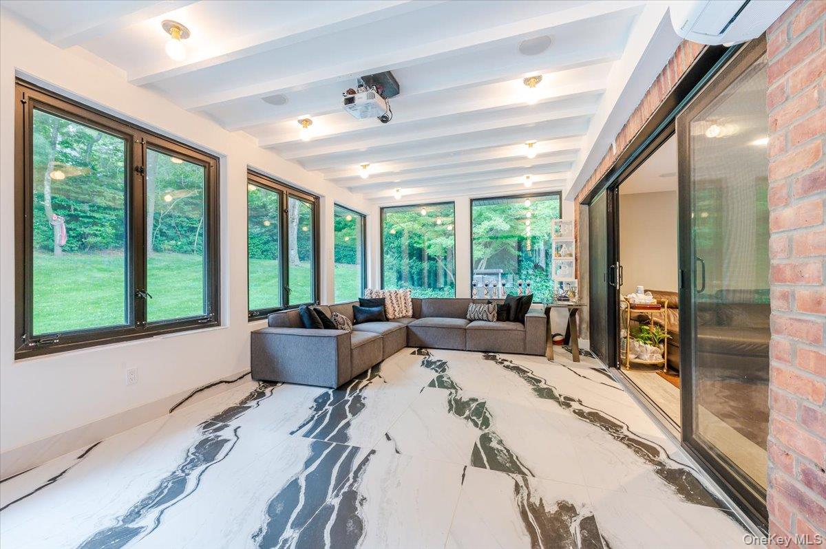 26 Redbrook Road Great Neck, NY 11024 - Photo 12 of 19 a living room with furniture and large windows