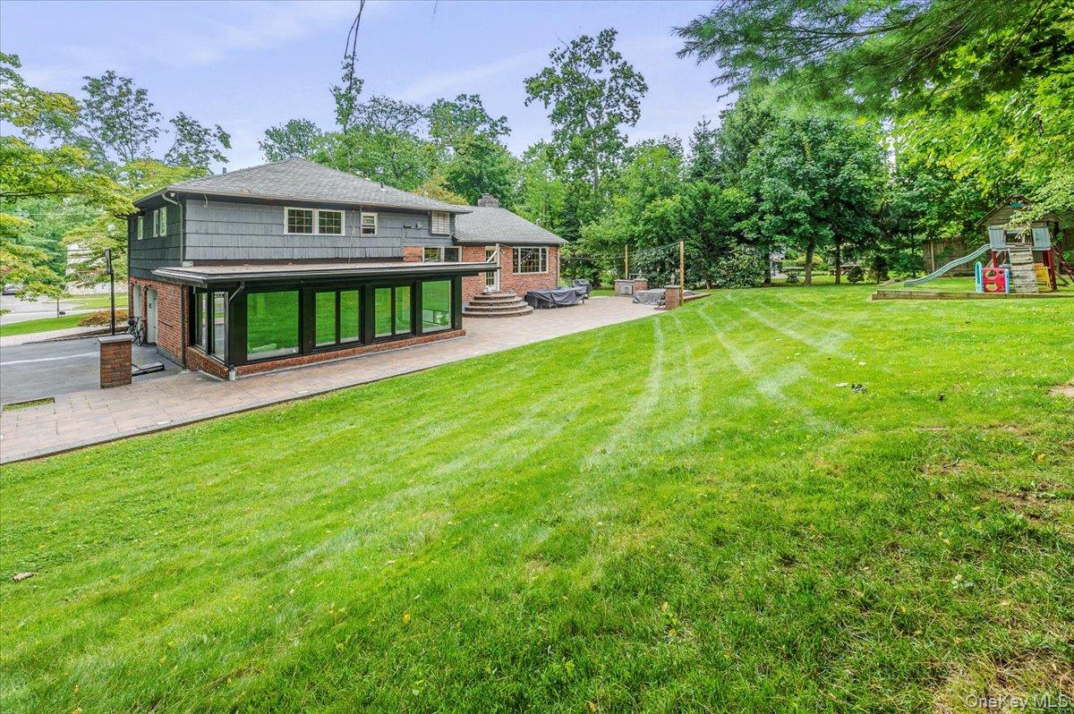 26 Redbrook Road Great Neck, NY 11024 - Photo 16 of 19 a view of a house with backyard and a sitting area