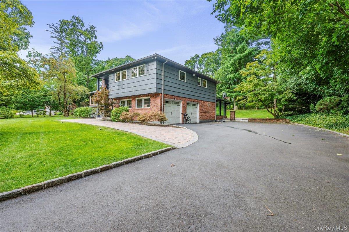 26 Redbrook Road Great Neck, NY 11024 - Photo 2 of 19 a view of an house with backyard and a tree