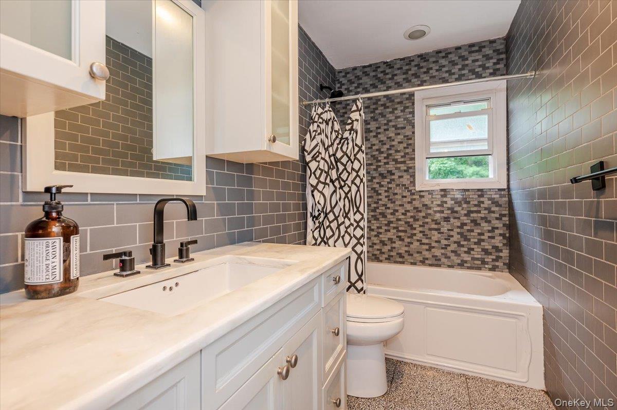 26 Redbrook Road Great Neck, NY 11024 - Photo 8 of 19 a bathroom with a sink a toilet and shower