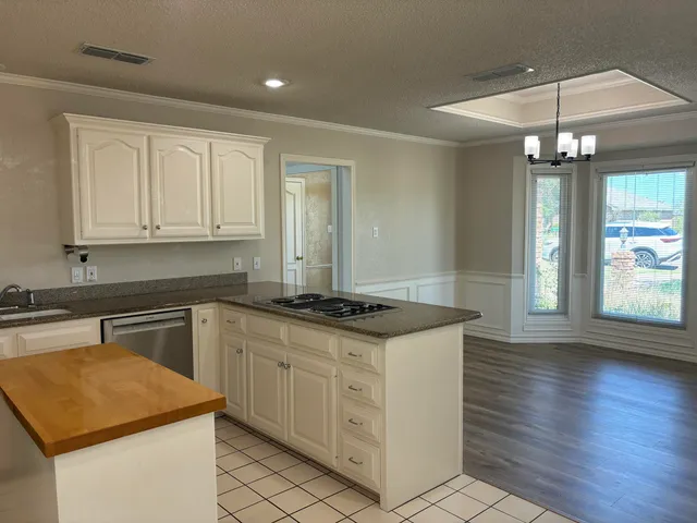 a view of a field with trees in the background