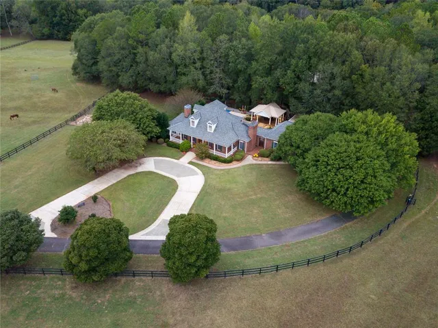 an aerial view of a house with garden space and street view