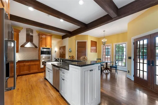 a view of a dining room with furniture wooden floor and chandelier