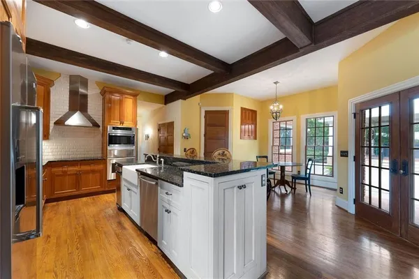 a bathroom with a double vanity sink a toilet a mirror and shower