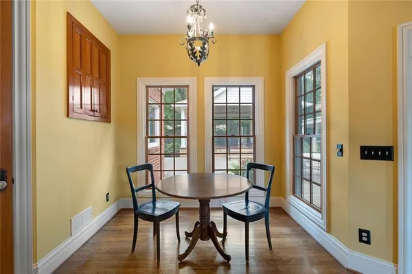 a view of a dining room with furniture window and wooden floor