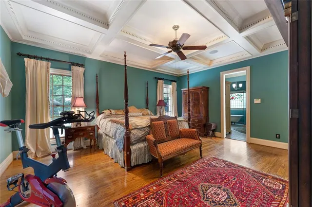 a bathroom with a double vanity sink a toilet a mirror and shower