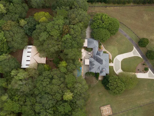 an aerial view of a house with pool yard and outdoor seating