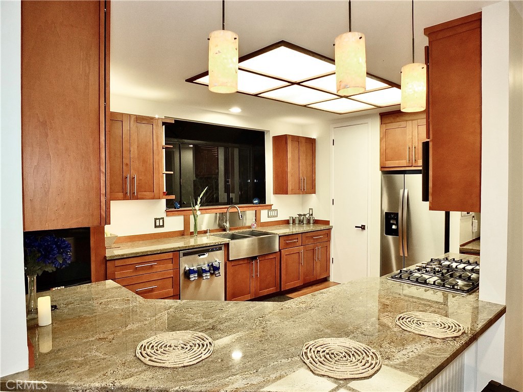 341 S Meadows Manhattan Beach, CA 90266 - Photo 12 of 50 a kitchen with stainless steel appliances kitchen island granite countertop a sink and cabinets