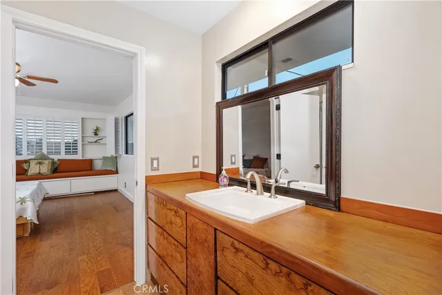 a bathroom with a granite countertop sink a toilet and shower