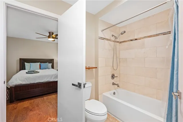 a bathroom with a granite countertop sink a toilet and shower