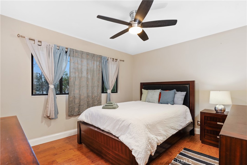 341 S Meadows Manhattan Beach, CA 90266 - Photo 31 of 50 a bedroom with a bed and a chandelier