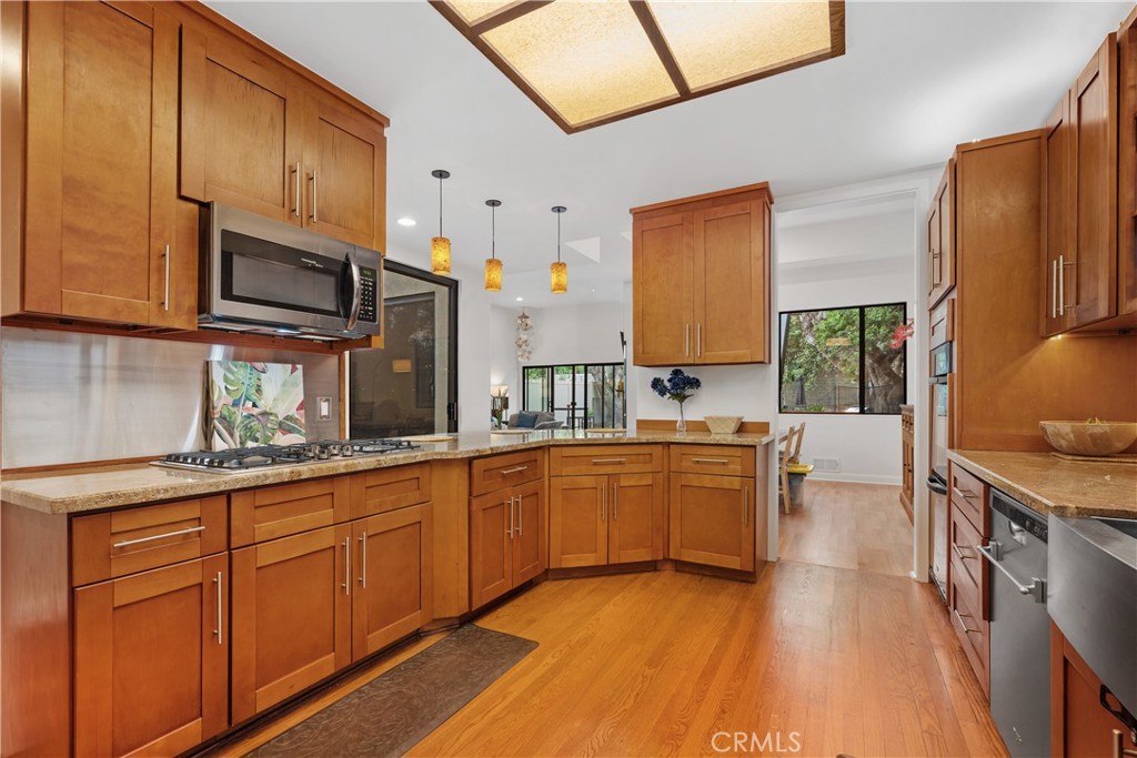 341 S Meadows Manhattan Beach, CA 90266 - Photo 8 of 50 a kitchen with stainless steel appliances granite countertop wooden cabinets a sink dishwasher a stove and a refrigerator