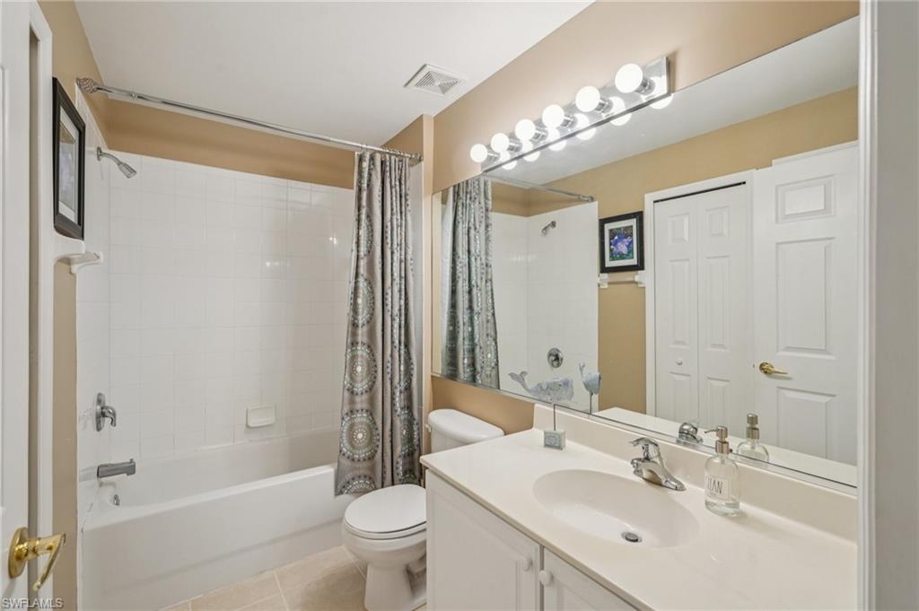 9583 Hemingway Lane, Unit 4309 Fort Myers, FL 33913 - Photo 12 of 18 a bathroom with a bathtub shower sink vanity mirror and toilet